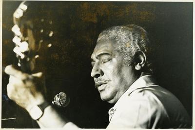 Dorival Caymmi ao microfone com o violão