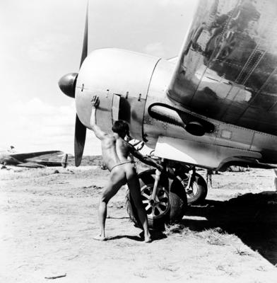 Homem do povo Yawalapiti com avião da FAB durante a Primeira Expedição Aeronáutica ao Brasil Central