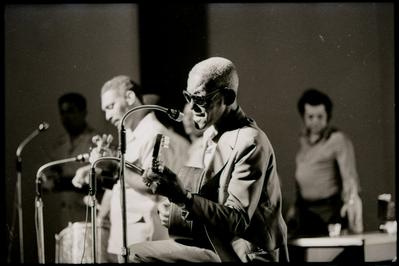 Cartola ao microfone com o violão